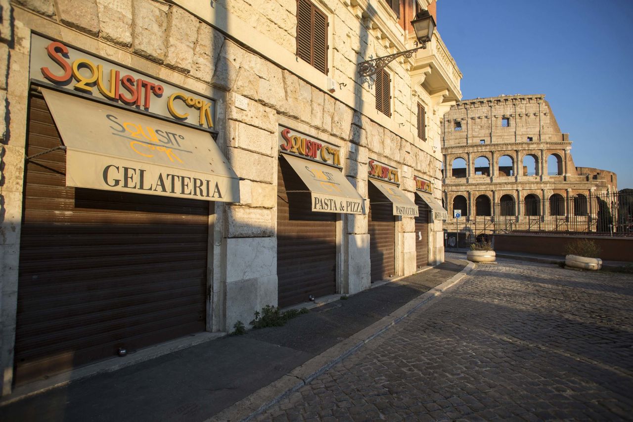 Closed businesses are pictured on a street near the Colosseum in Rome, during coronavirus lockdown on April 11.