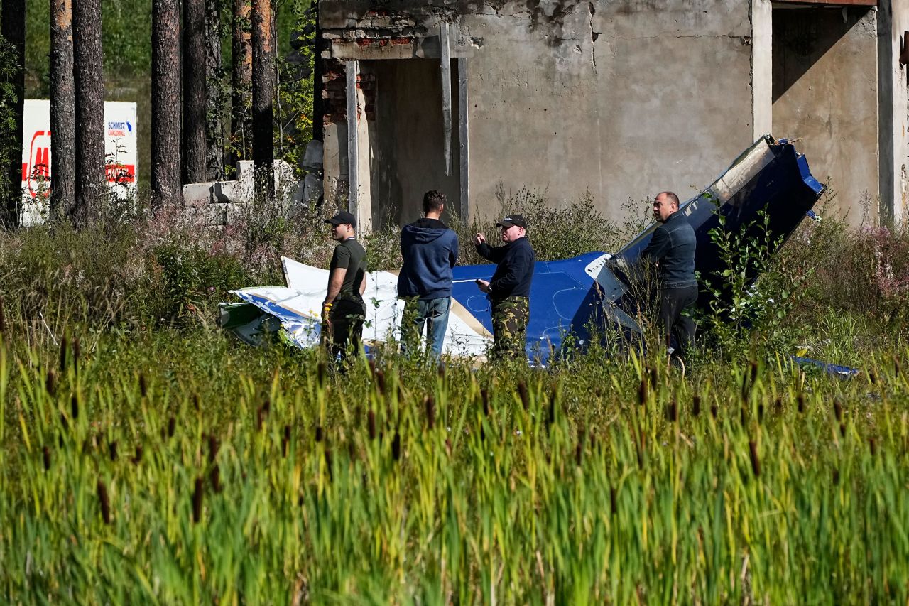 Russian servicemen inspect a part of the crashed private jet in Tver region, Russia, on August 24. 