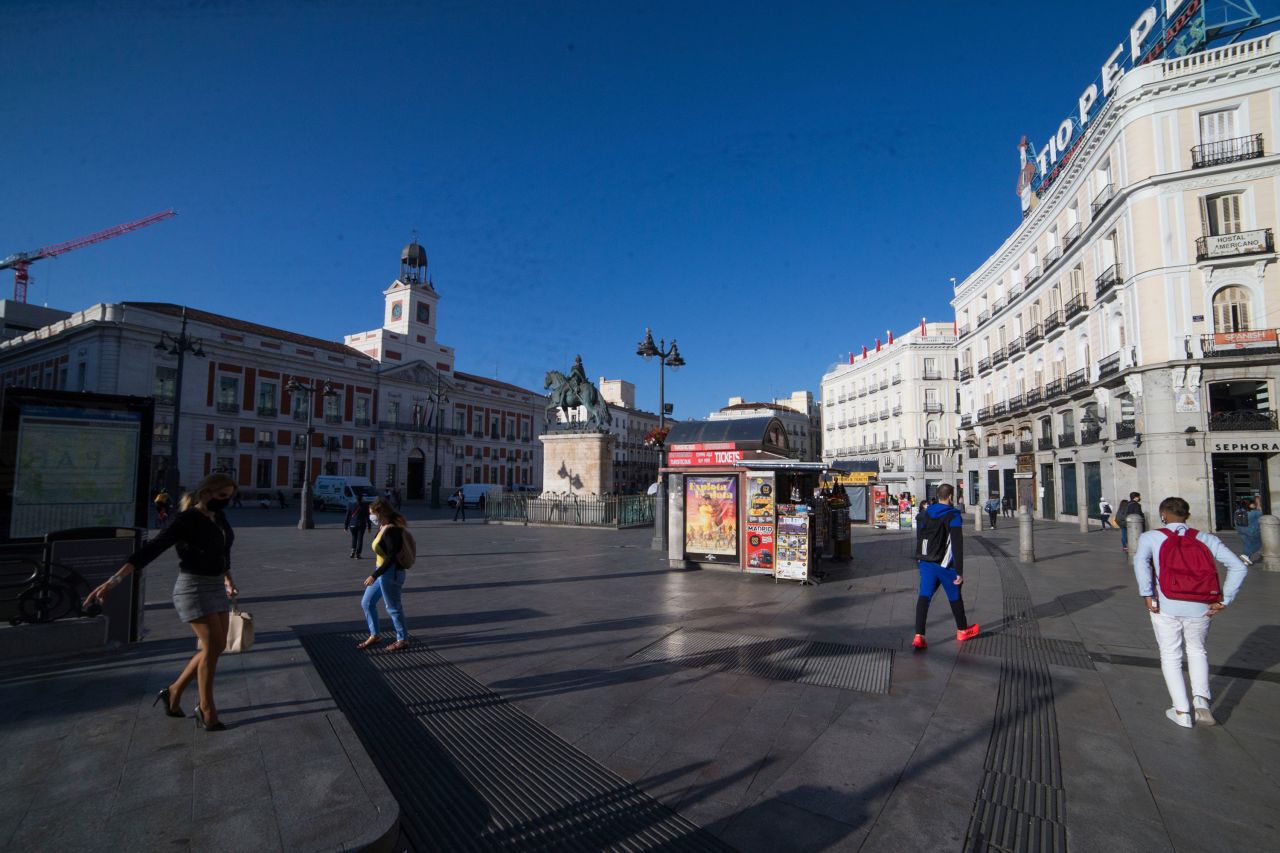 People walk through the Puerta del Sol in Madrid on October 9.