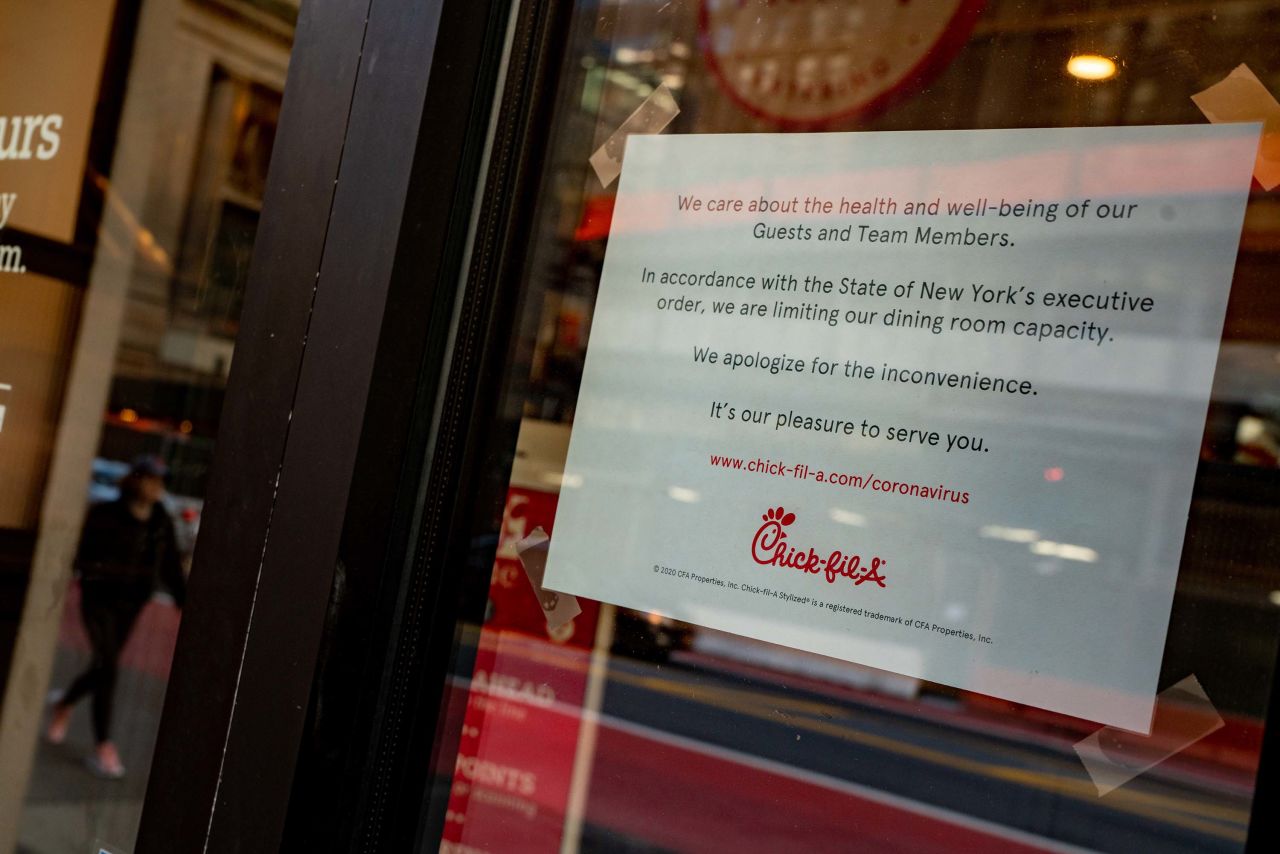 A sign at a Chick-Fil-A in New York informs customers of limited dining room capacity, on March 14.