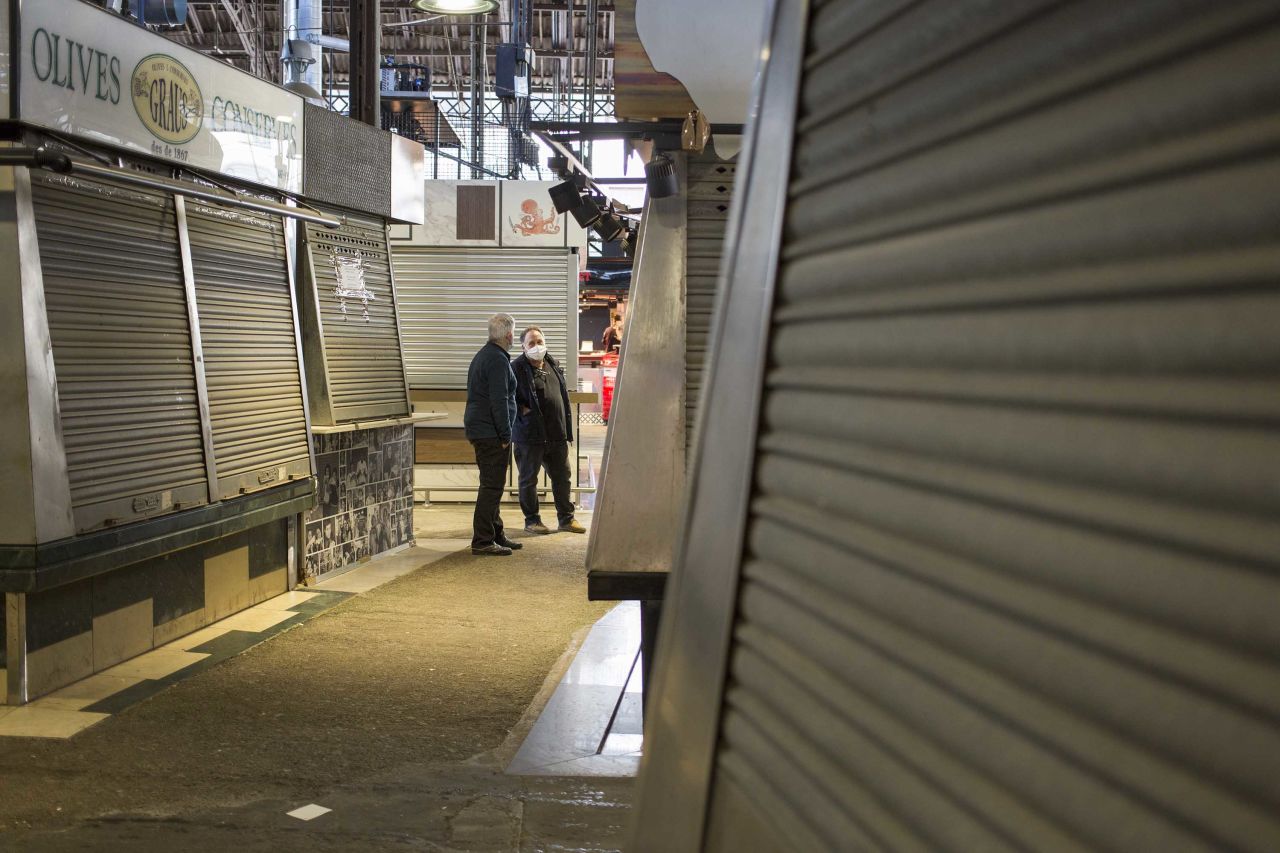 Workers are seen amid closed stalls at a market in Barcelona, Spain, on April 23.