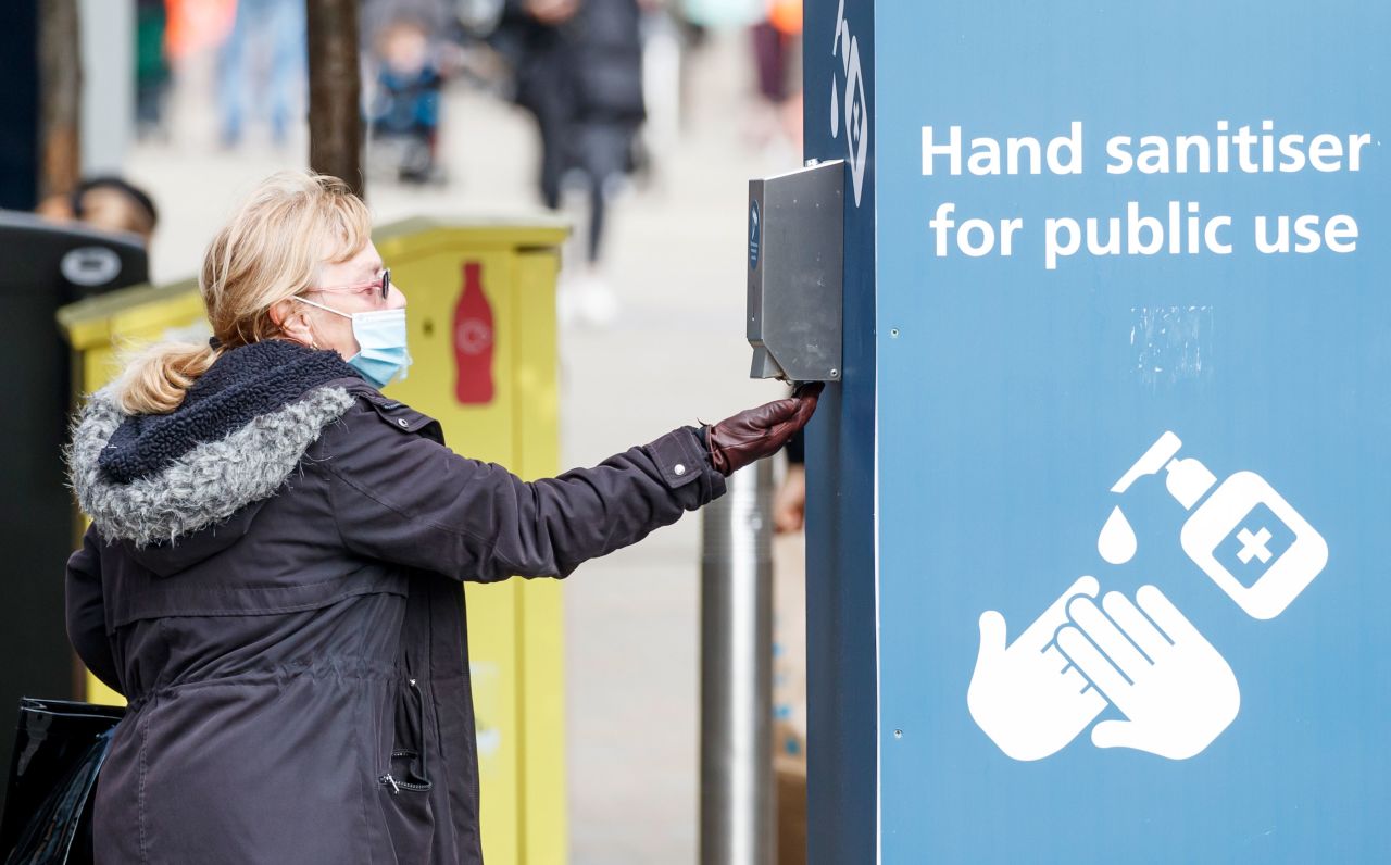 A woman uses hand sanitizer in Leeds, England, on September 11.