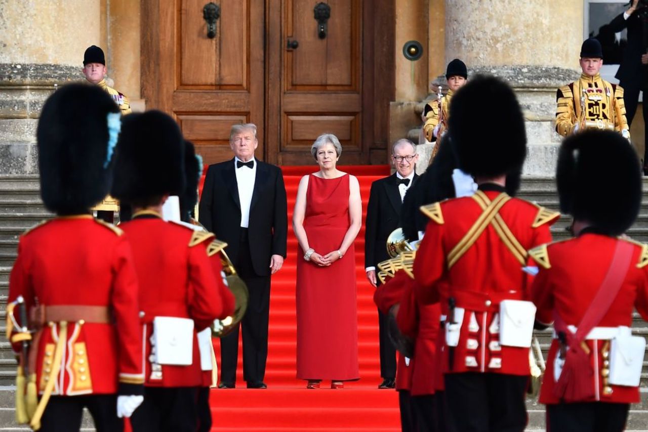 US President Donald Trump, Britain's Prime Minister Theresa May and her husband Philip May stand on steps in the Great Court at Blenheim Palace, west of London, on July 12, 2018. 