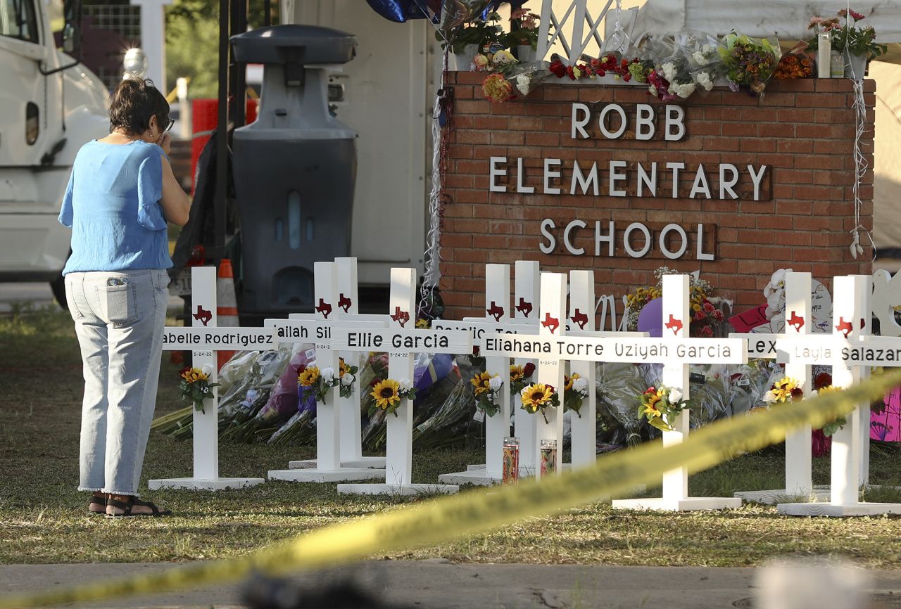 Dora Mendoza, grandmother to victim Amerie Jo Garza, wipes tears from her eyes as she pays respects to her granddaughter and others at a memorial site for the victims of the Robb Elementary School shooting, on May 26.