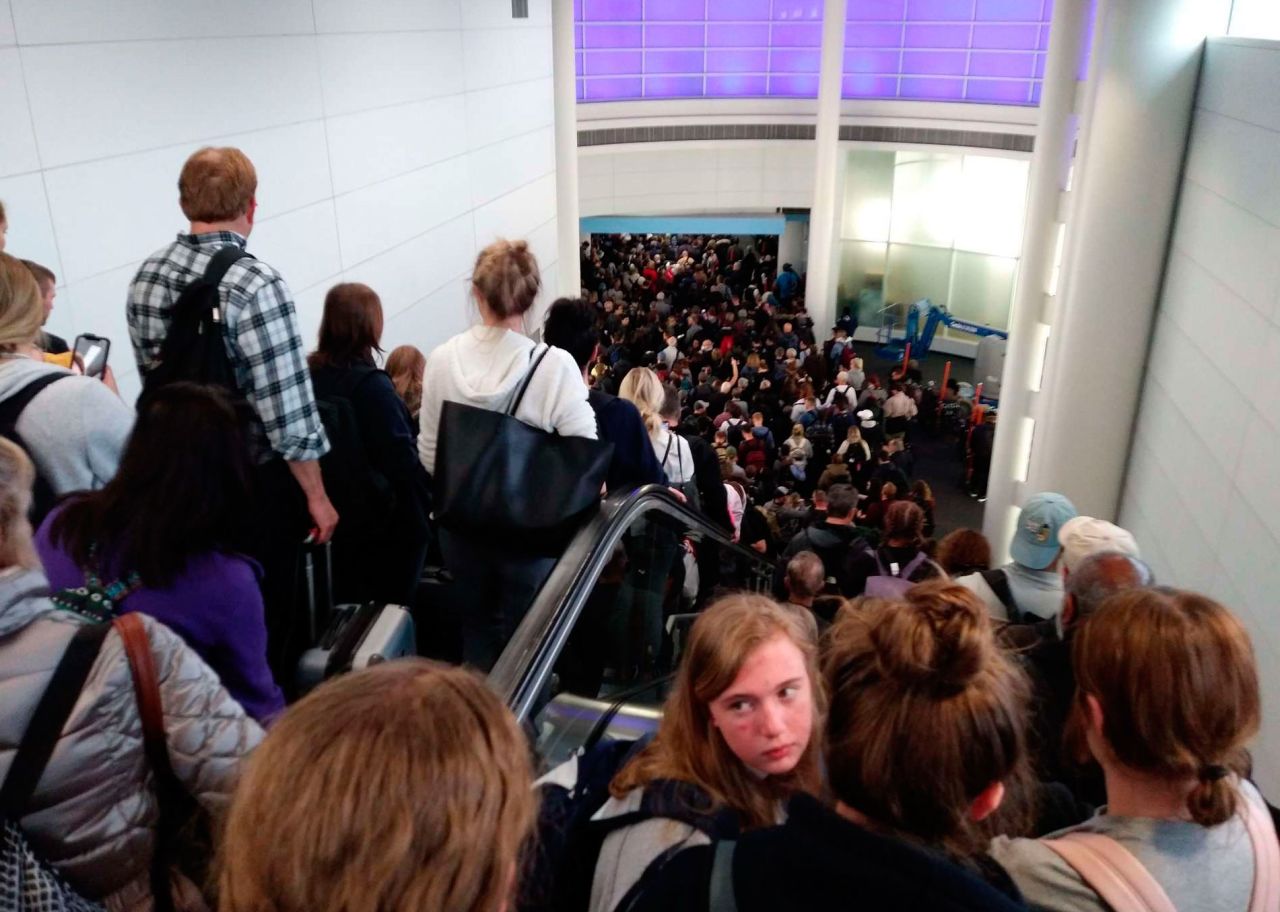 Travelers wait to go through customs at O'Hare International Airport in Chicago on March 15. 