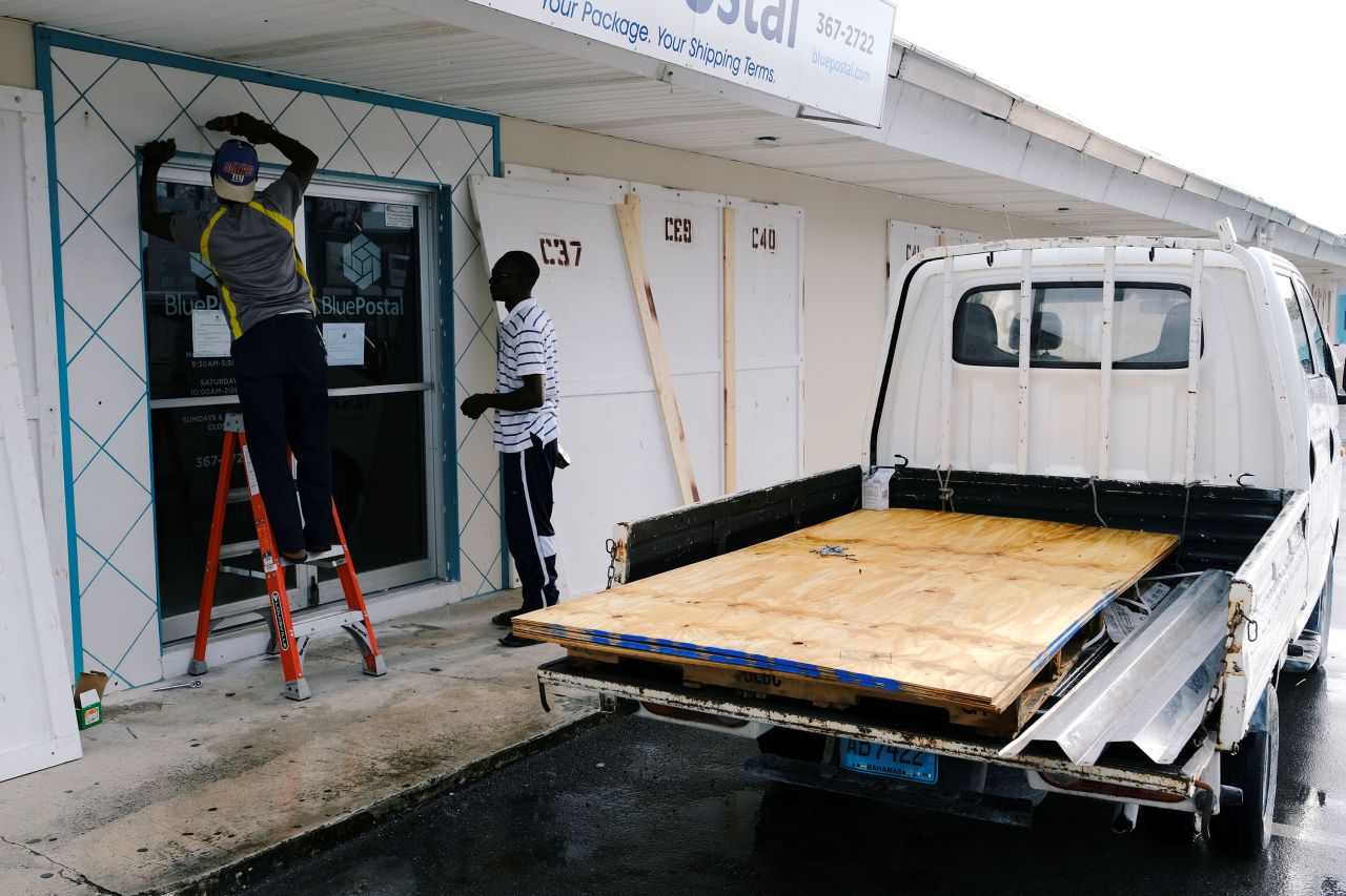 Workers install storm shutters Saturday ahead of Hurricane Dorian's arrival in Marsh Harbour on the Great Abaco Island in the Bahamas. 