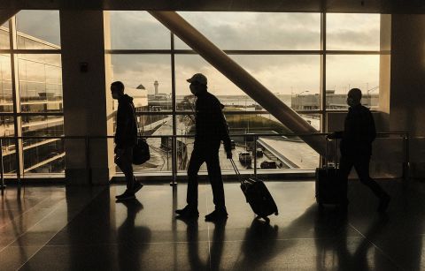 Travelers walk through the Detroit Metropolitan Wayne County Airport on November 21, 2021 in Detroit, Michigan. 