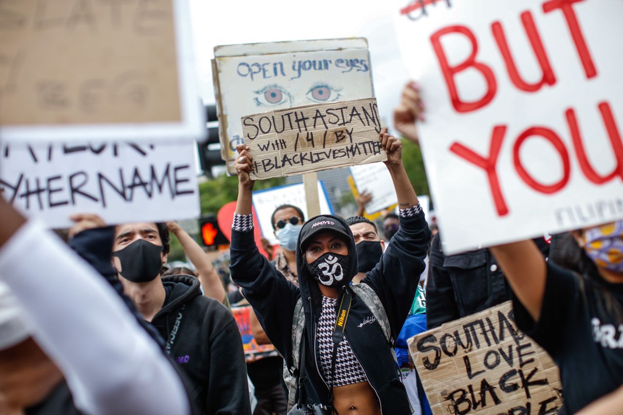 A woman holding a sign reading "South Asians with / 4 / by Black Lives Matter," as protesters gathered in the death of George Floyd and support of Black Lives Matter, in Los Angeles, on Friday, June 5. 