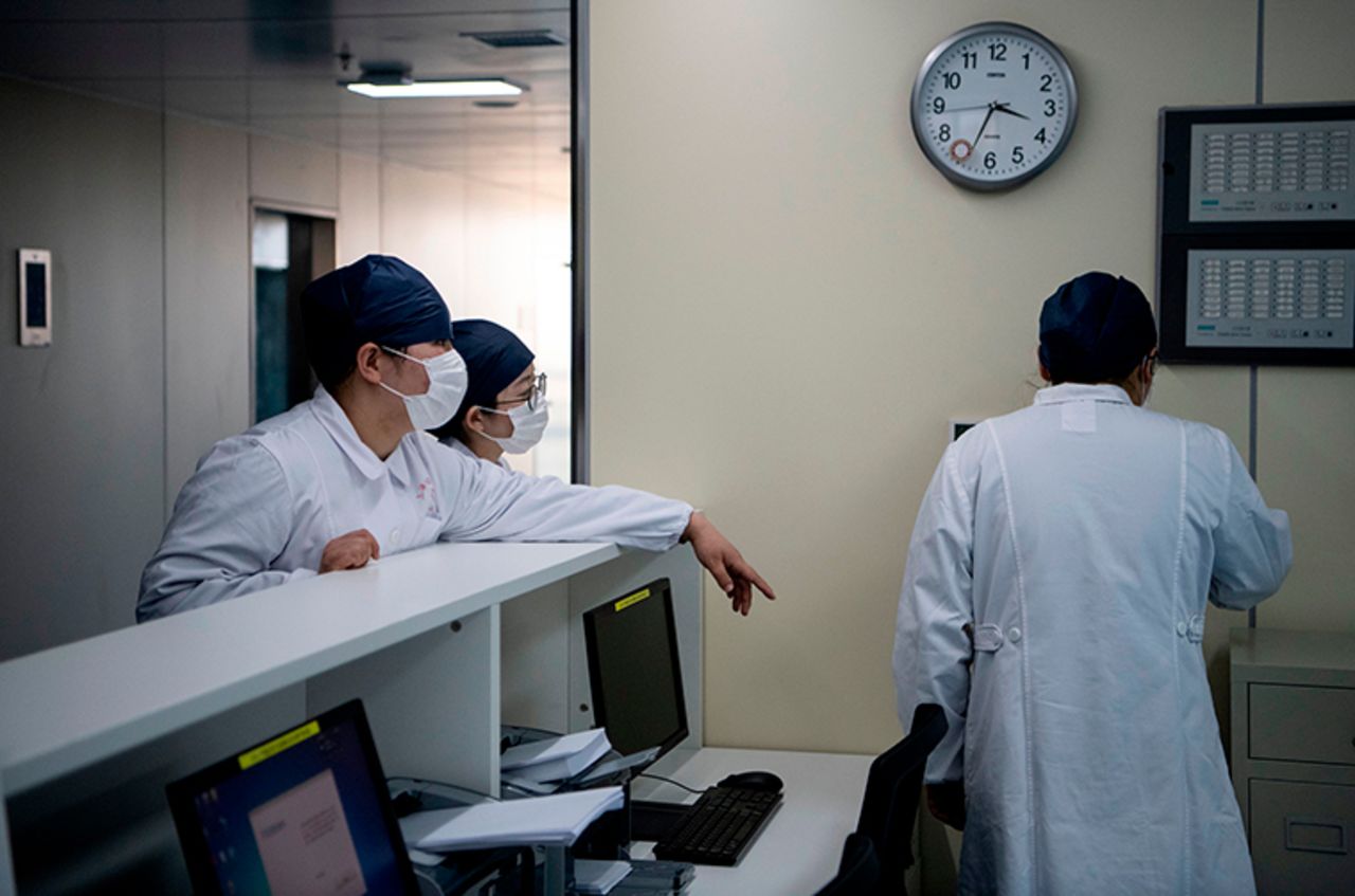 Nurses talk inside the finished but still unused building A2 of the Shanghai Public Clinical Center, where coronavirus patients will be quarantined, in Shanghai on February 17.