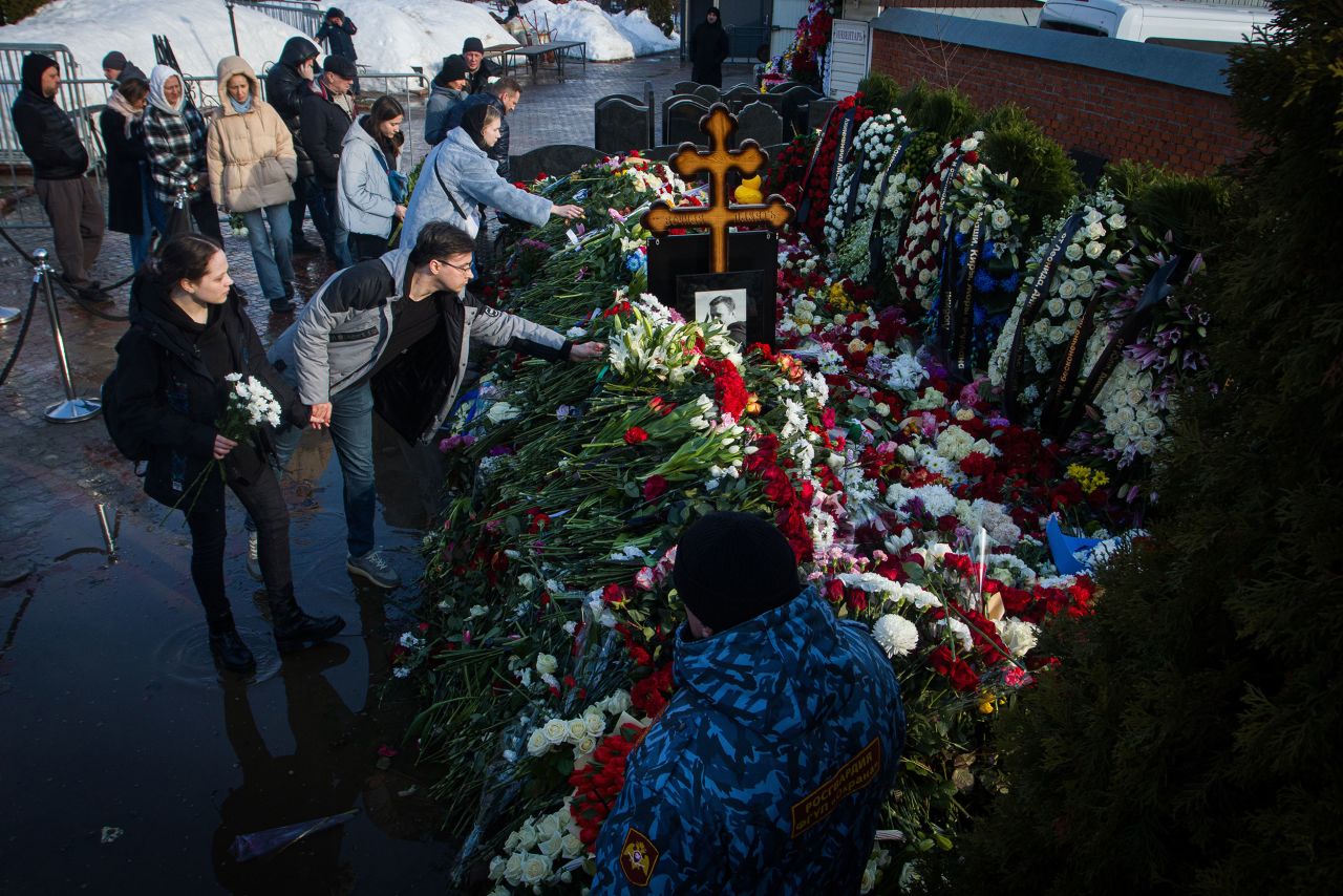 People lay flowers at the grave of Russian opposition leader Alexey Navalny at the Borisov Cemetery in Moscow, on March 2.