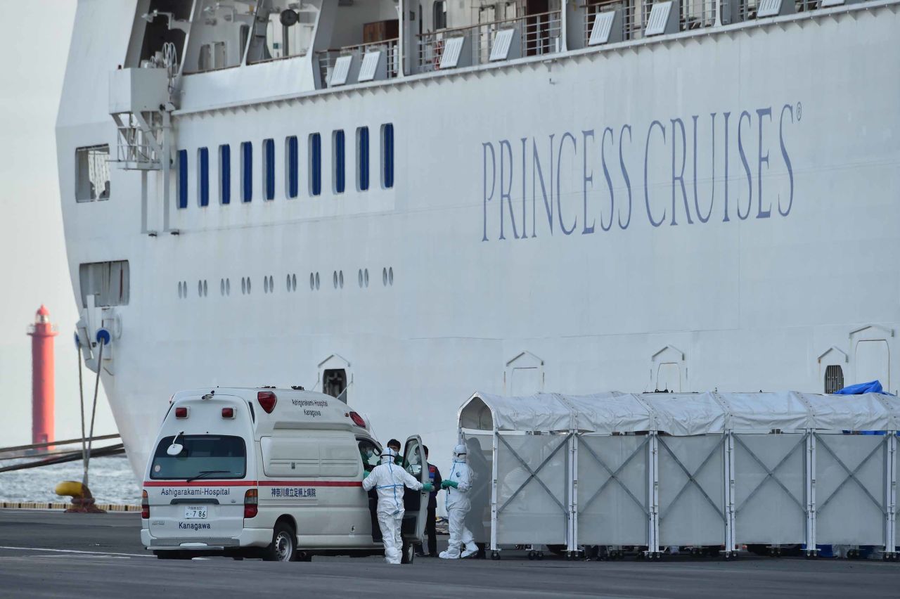 Medical personnel prepare to transfer passengers suspected of being infected with the coronavirus aboard the Diamond Princes cruise ship, docked at the Daikoku Pier Cruise Terminal in Yokohama, Japan, on Friday.