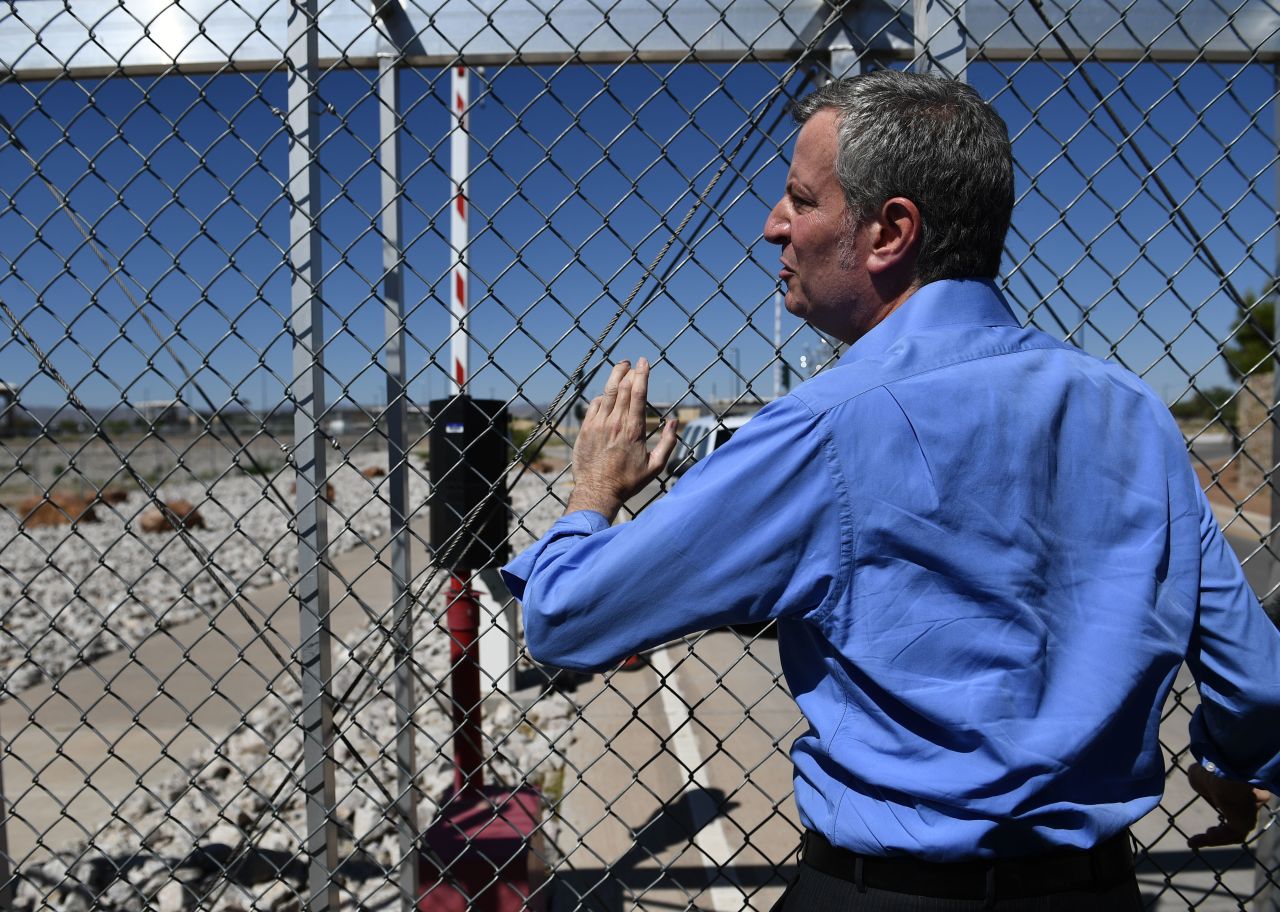 New York mayor Bill de Blasio stands at a fence of the Tornillo Port of Entry near El Paso, Texas, Thursday during a protest rally.