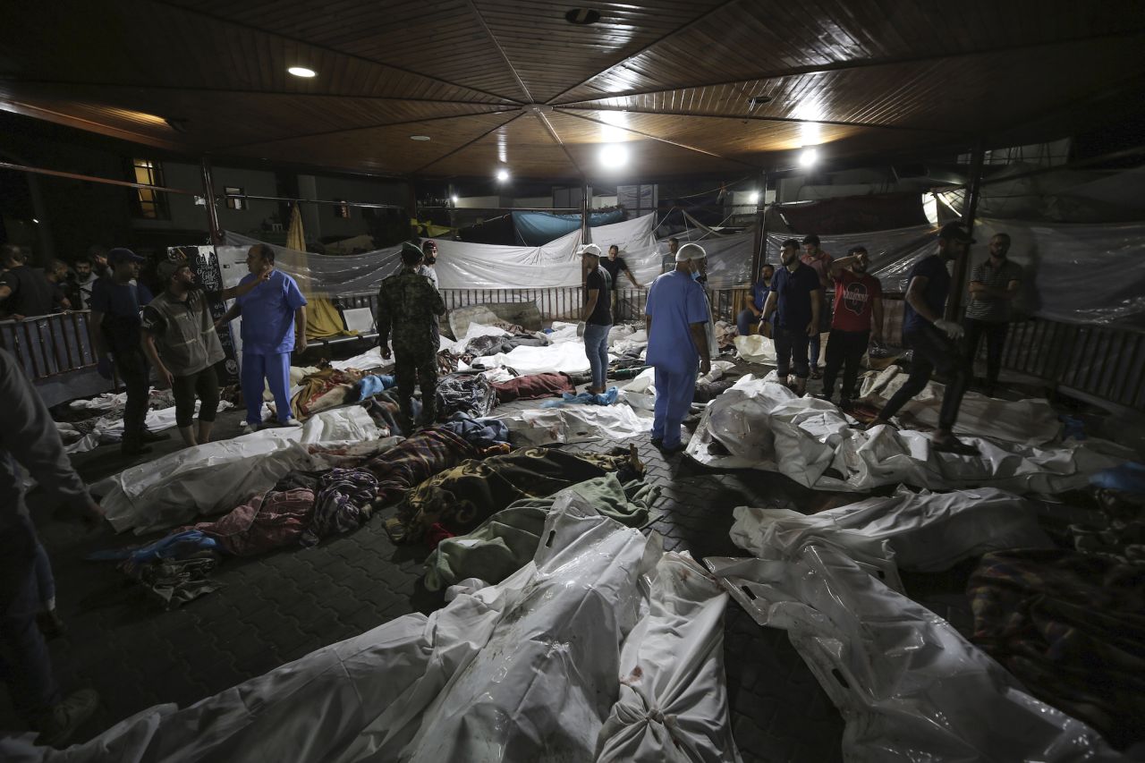 Bodies of Palestinians killed by an explosion at the Al-Ahli Hospital are gathered in the front yard of the Al-Shifa hospital, in Gaza City on October 17.