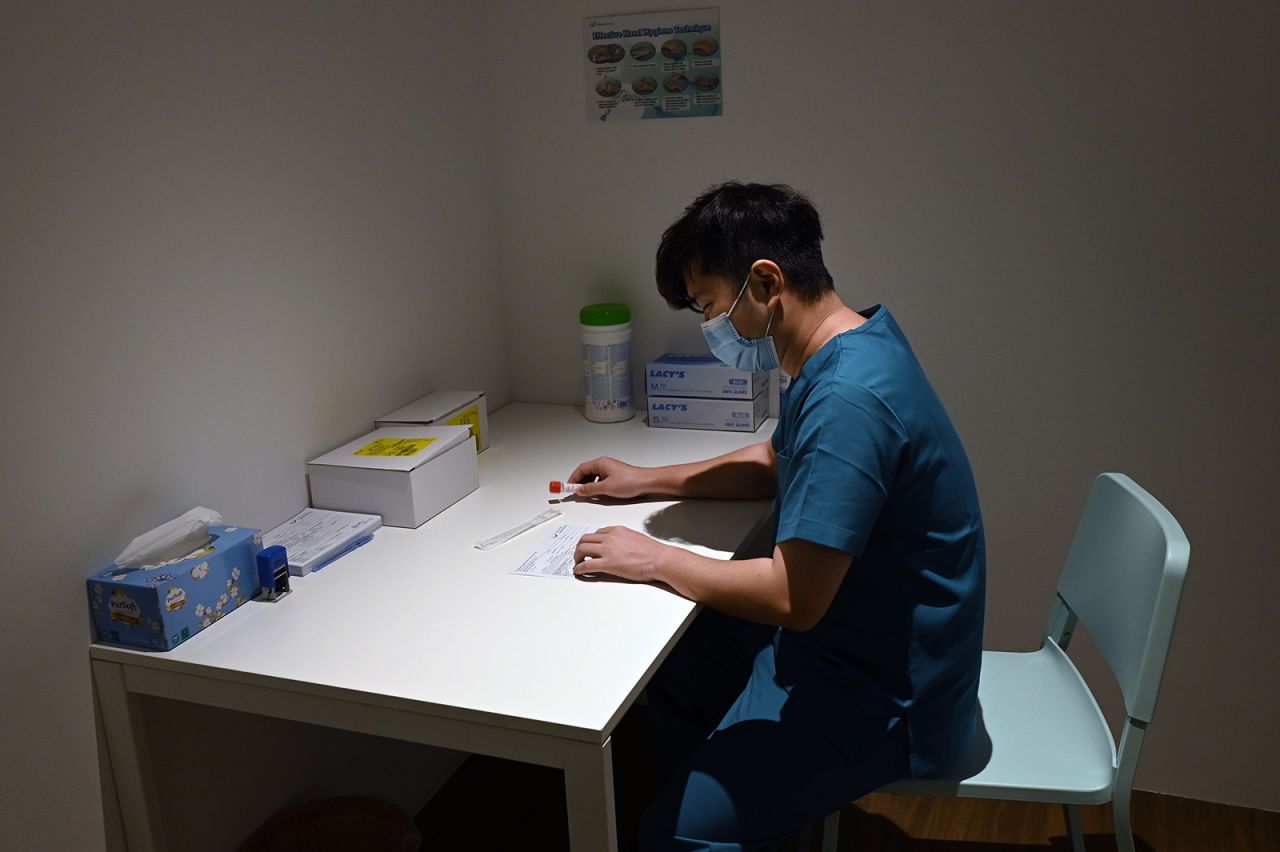 A health staff prepare test-kit for guests at the Connect@Changi, billed as the world's first coronavirus-safe hotel and conference complex is pictured in Singapore on February 18.