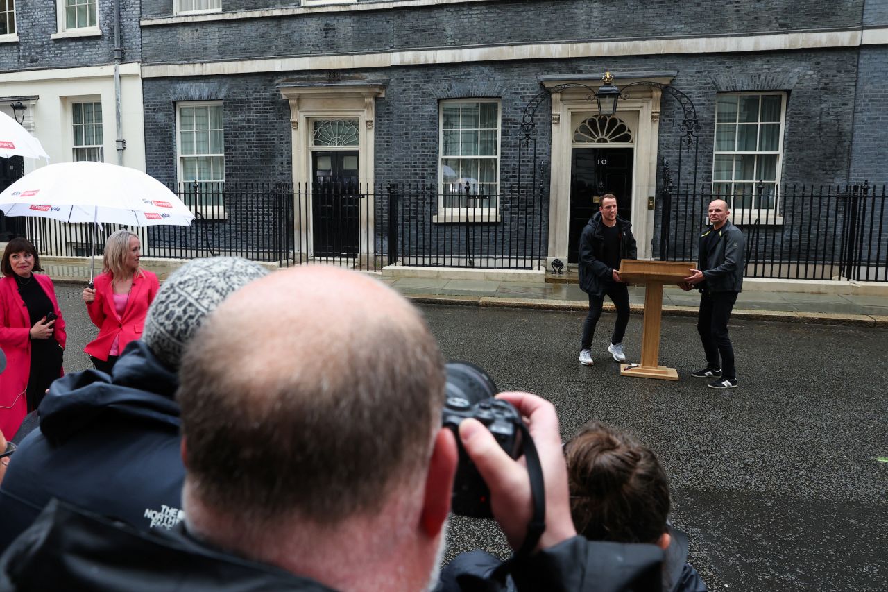 Workers carry a podium outside 10 Downing Street ahead of a speech by British Prime Minister Rishi Sunak in London on Wednesday.