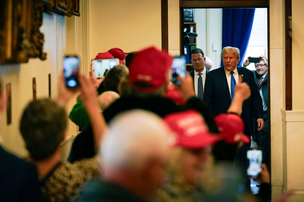 Former President Donald Trump arrives to signs papers to be on the 2024 Republican presidential primary ballot at the New Hampshire Statehouse, on Monday in Concord, New Hampshire.