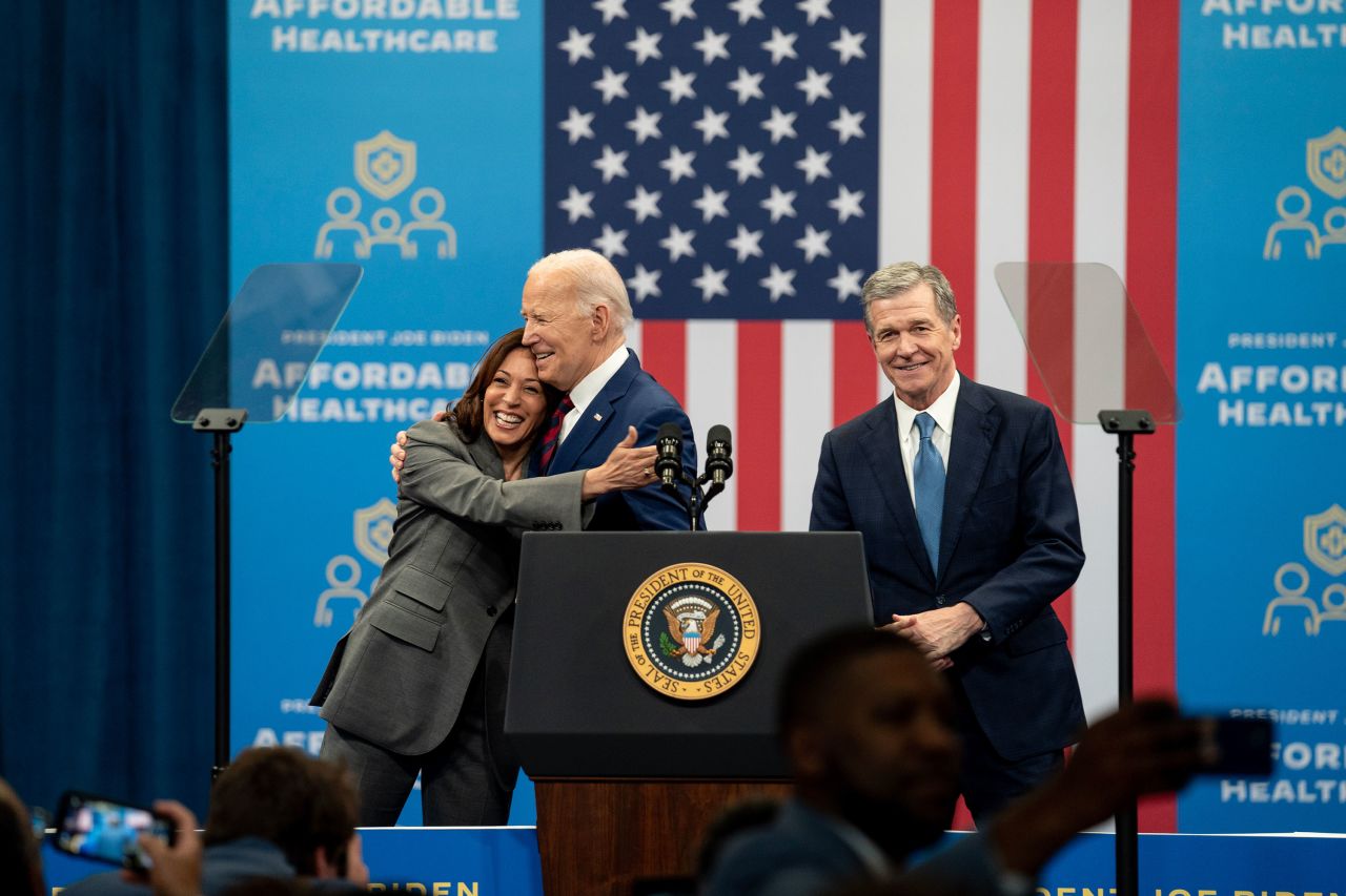 President Joe Biden hugs Vice President Kamala Harris as North Carolina Governor Roy Cooper looks on during an event at the Chavis community center on March 26, in Raleigh, North Carolina.?