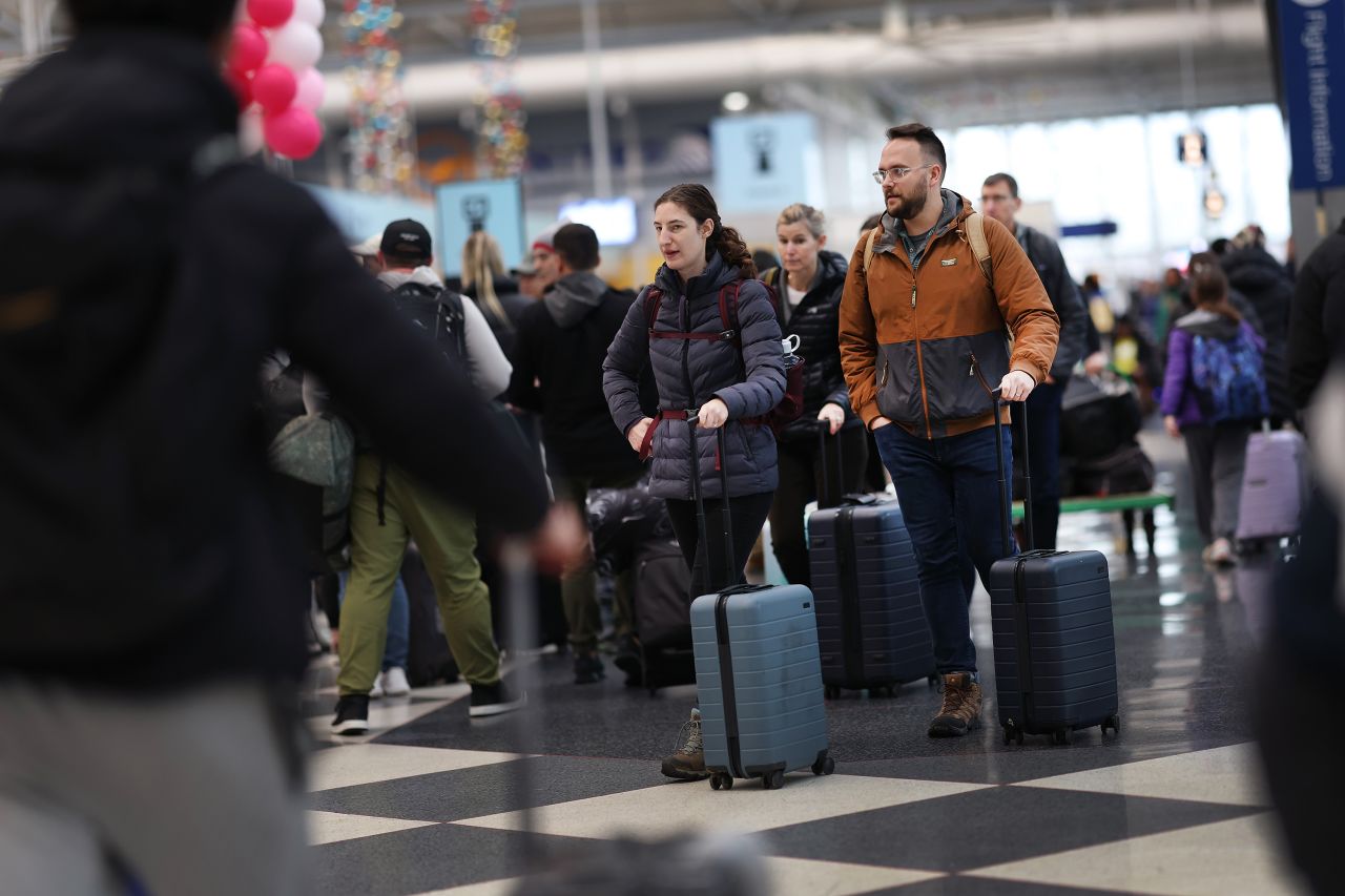 Travelers pass through O'Hare Airport as Thanksgiving holiday travel heads into full swing on November 21, in Chicago, Illinois.