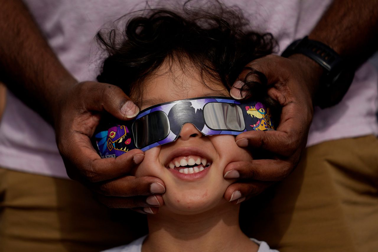 Viewers use special glasses during an annular solar eclipse, in San Antonio, Texas, in October 2023.