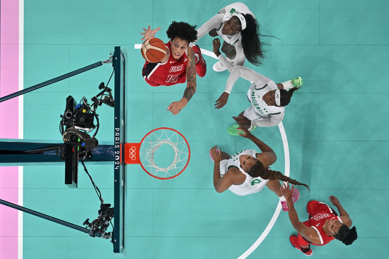 An overview shows USA's #15 Brittney Griner (Top C) go for a rebound next to Nigeria's #33 Nicole Enabosi (Top R) in the women's quarterfinal basketball match between Nigeria and USA today at the Bercy Arena in Paris.