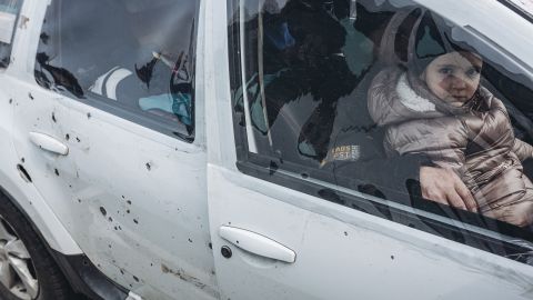 A child sits in a car after arriving in Zaporizhzhya, Ukraine with a a shrapnel-damaged car after fleeing from Mariupol on March 30.