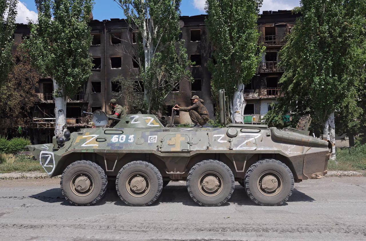 Russian troops ride on top of an armored personnel carrier in the city of Lysychansk in the Luhansk Region, Ukraine, on July 4.