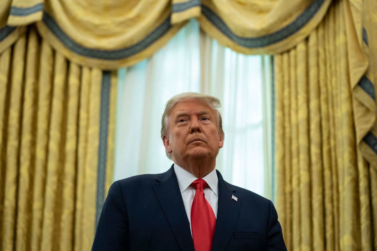 President Donald Trump listens during a ceremony to present the Presidential Medal of Freedom to former football coach Lou Holtz on Thursday, December 3 in the White House.