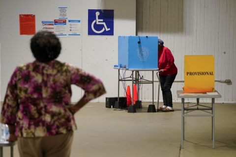 A person uses a voting machine to fill out and cast their ballot as early voting continues for the midterm elections at a polling location in Americus, Georgia, on Tuesday, October 25.