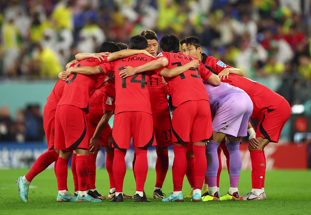 South Korea players gather in a huddle before the start of the second half against Brazil on December 5.