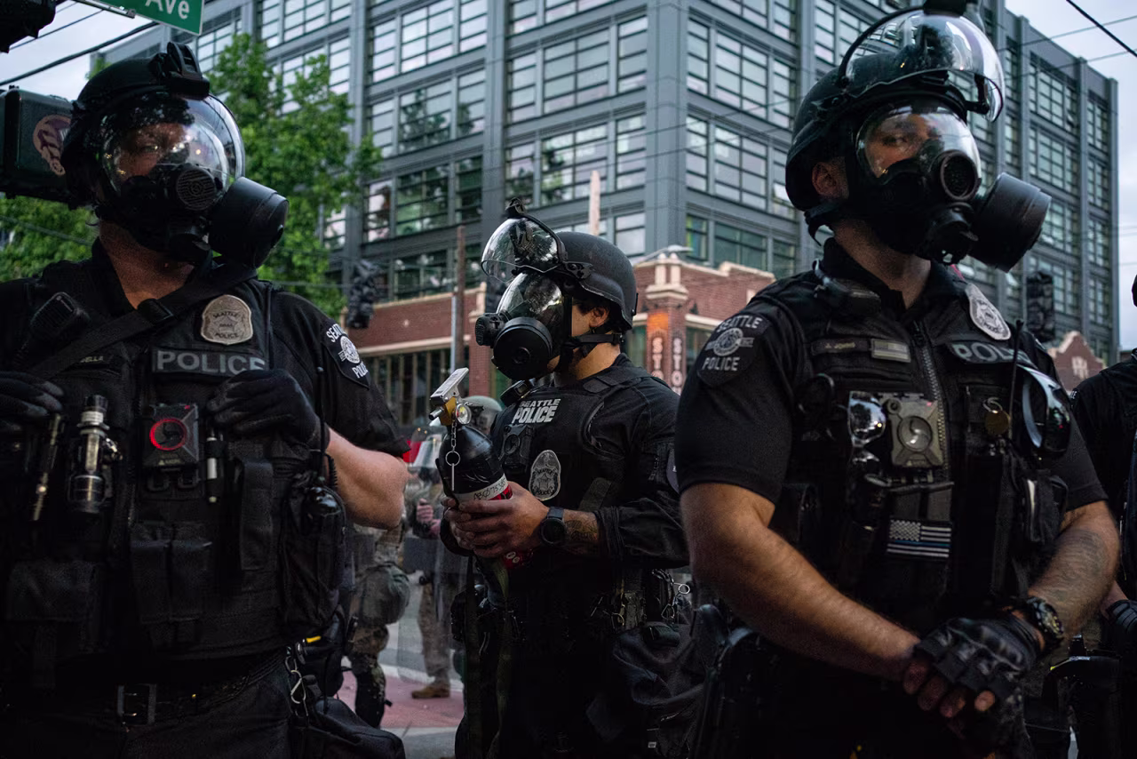 Police officers face off with demonstrators near the Seattle Police Department's East Precinct in Seattle, on June 6.