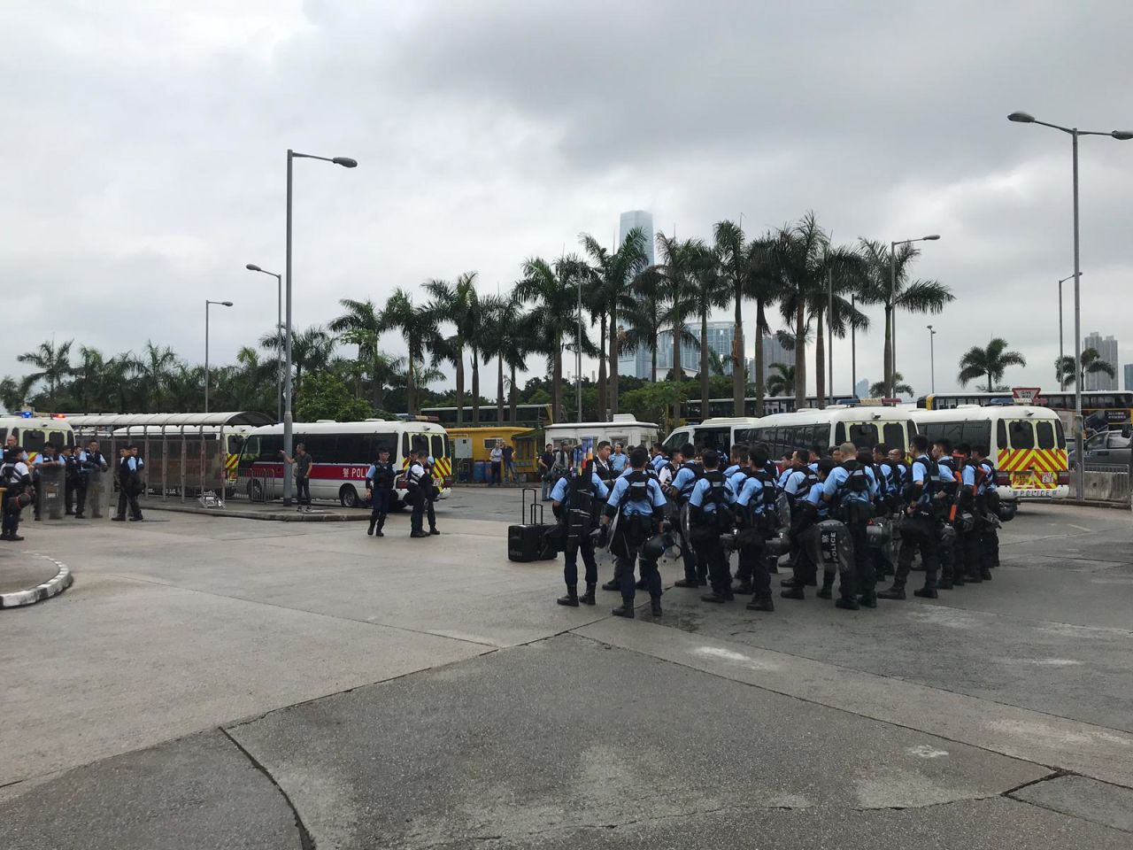 Police reinforcements gather by the International Finance Center in Hong Kong.