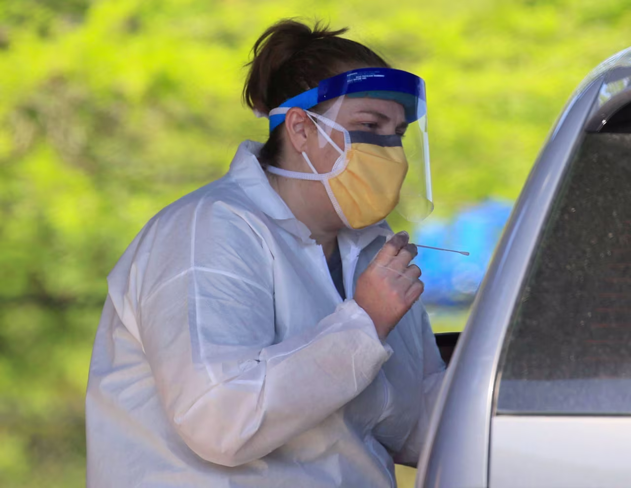 Nurse Tonya Green administers a coronvirus test at a drive-thru testing center in North Little Rock, Arkansas, on April 20.