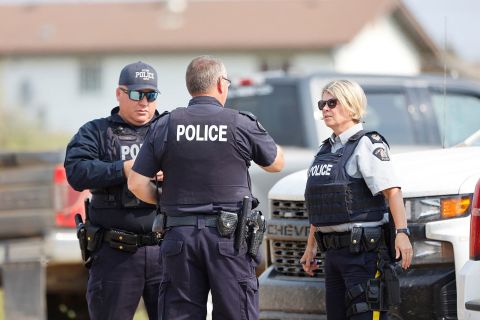 Manhunt Underway In Canada After Deadly Mass Stabbing | CNN 4 Royal Canadian Mounted Police officers at James Smith Cree Nation talk to each other on September 5.