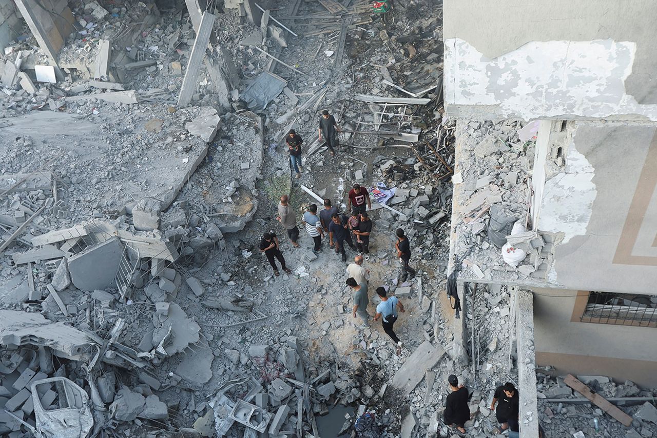 Palestinians inspect a house hit in an Israeli strike in the Nuseirat refugee camp in central Gaza, on June 8, 2024. 