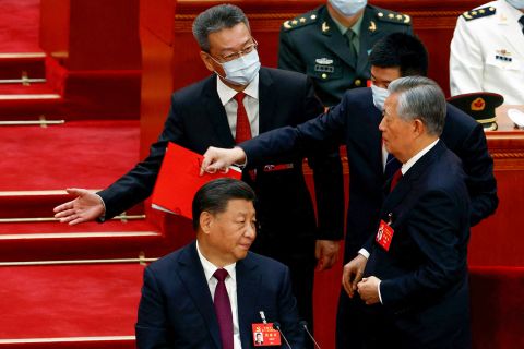 Former Chinese president Hu Jintao leaves his seat next to Chinese President Xi Jinping during the closing ceremony of the 20th National Congress of the Communist Party of China, at the Great Hall of the People in Beijing  October 22, 2022. REUTERS/Tingshu Wang