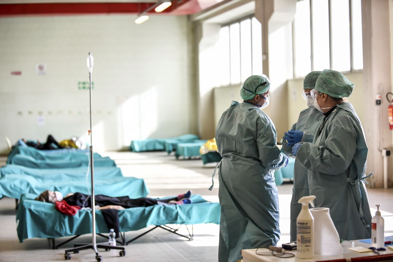 Medical personnel work inside one of the emergency structures that were set up to ease procedures at the hospital of Brescia, in Northern Italy, on Tuesday, March 10.