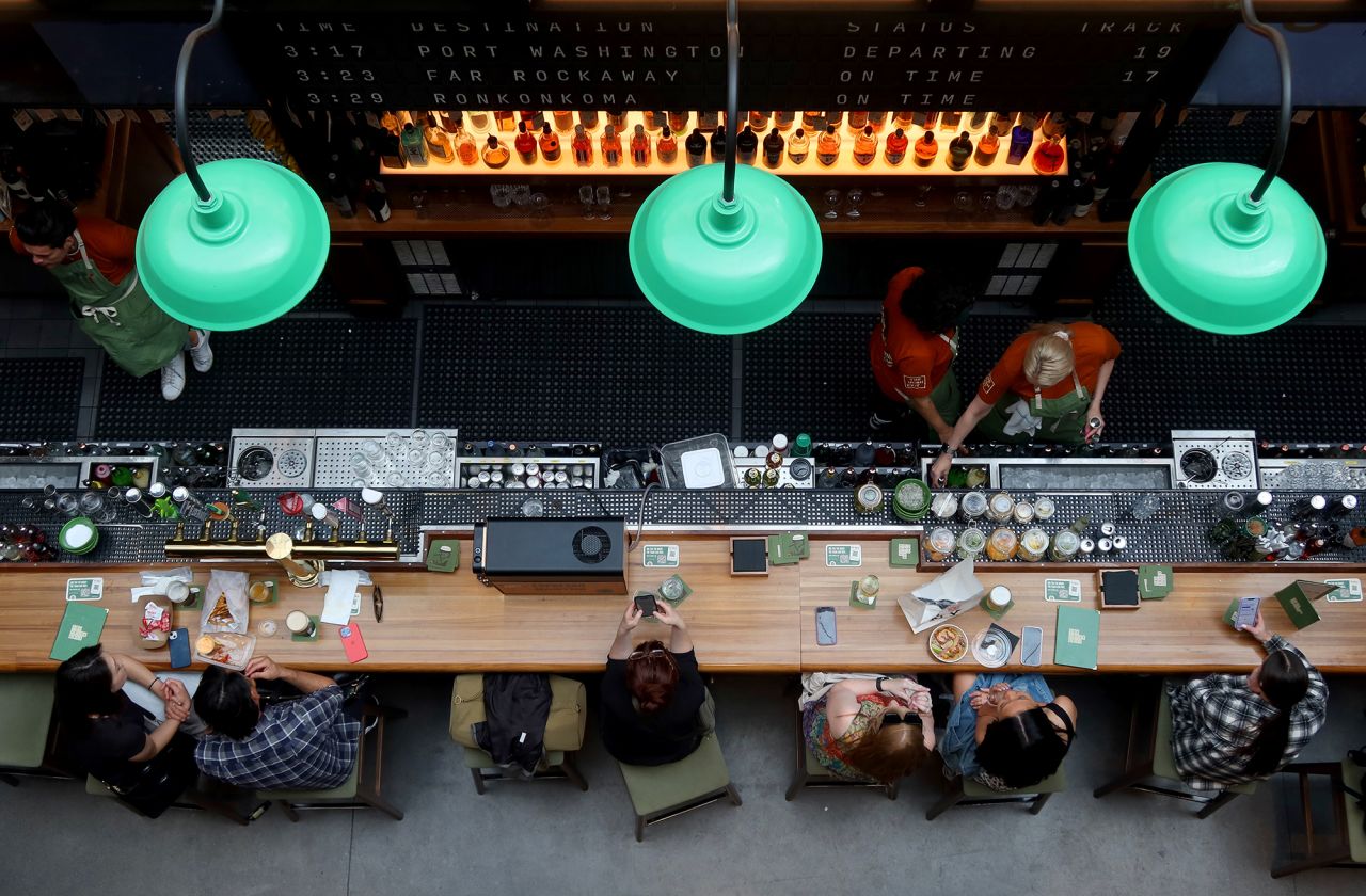 People have lunch at a restaurant at the Moynihan Train Hall on May 11, 2023, in New York City.