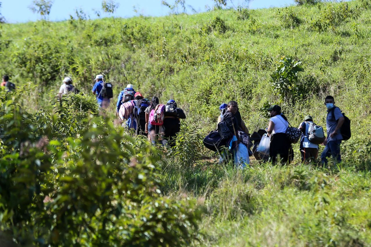 In this January 2022 photo, migrants wanting to reach the US, mostly Hondurans and Nicaraguans, cross from Honduras to Guatemala.