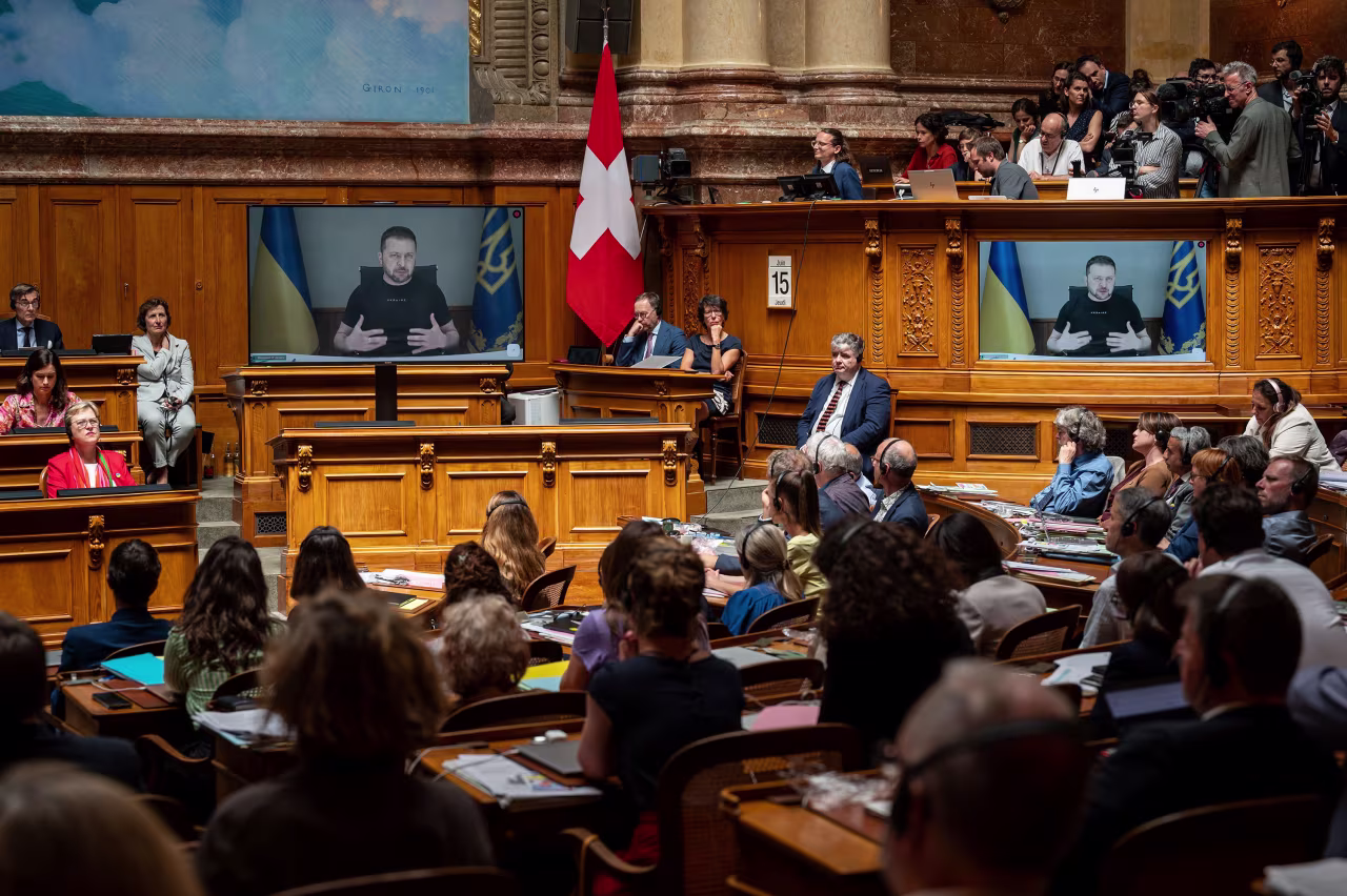 Ukrainian President Volodymyr Zelensky is seen on screens addressing Swiss parliament via video in Bern, Switzerland, on June 15. 