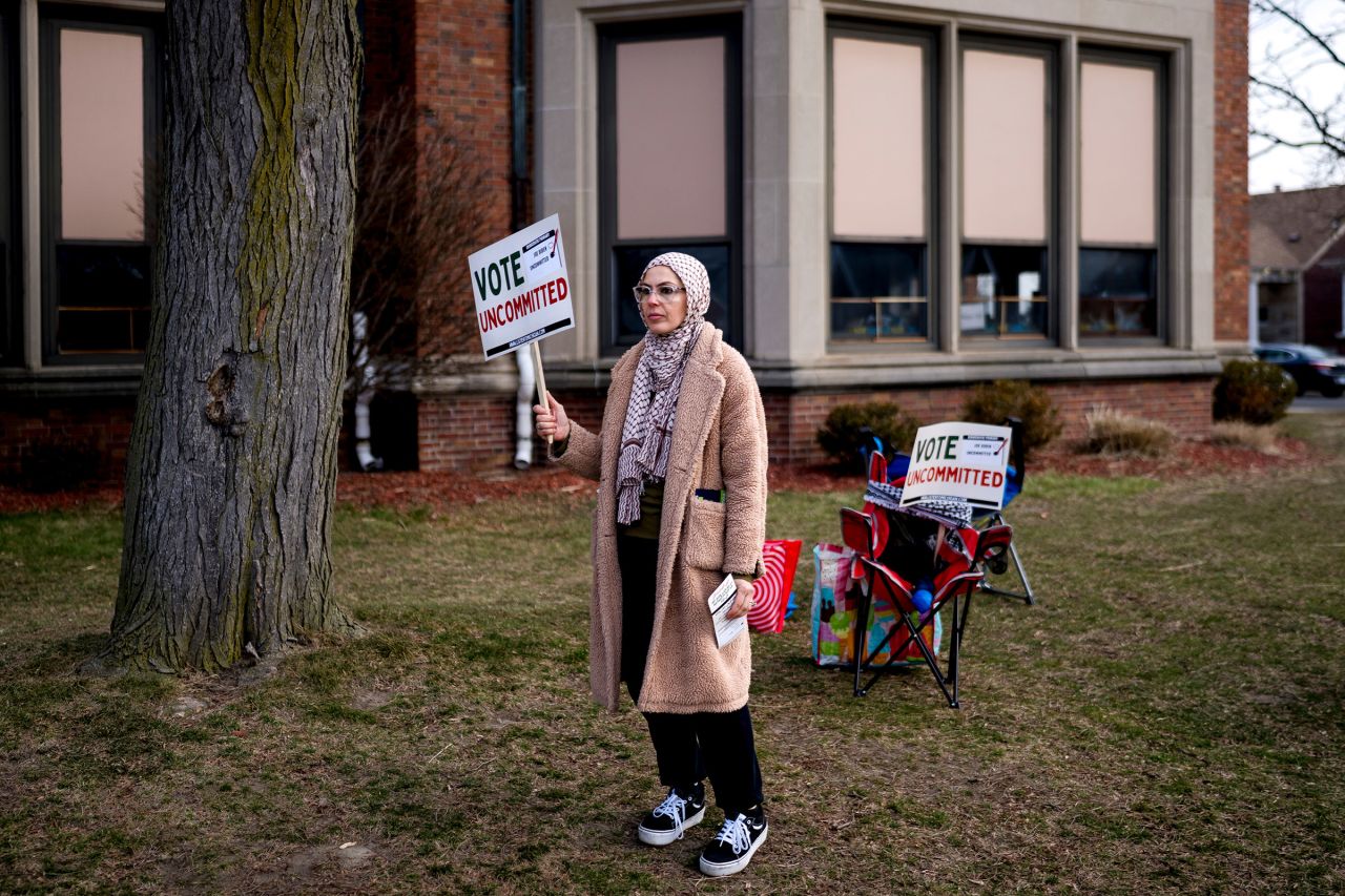 A volunteeer holds a "Vote Uncommitted" sign outside of a polling station at Maples Elementary School in Dearborn, Michigan, on Tuesday, February 27.