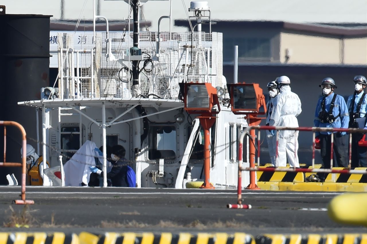 Workers in protective gear at the Japan Coast Guard base in Yokohama on February 5, 2020.