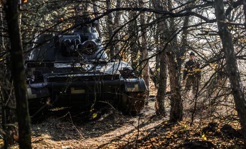 A Ukrainan soldier stands beside a self-propelled 2S3 gun in the Kherson region, Ukraine, on October 29,