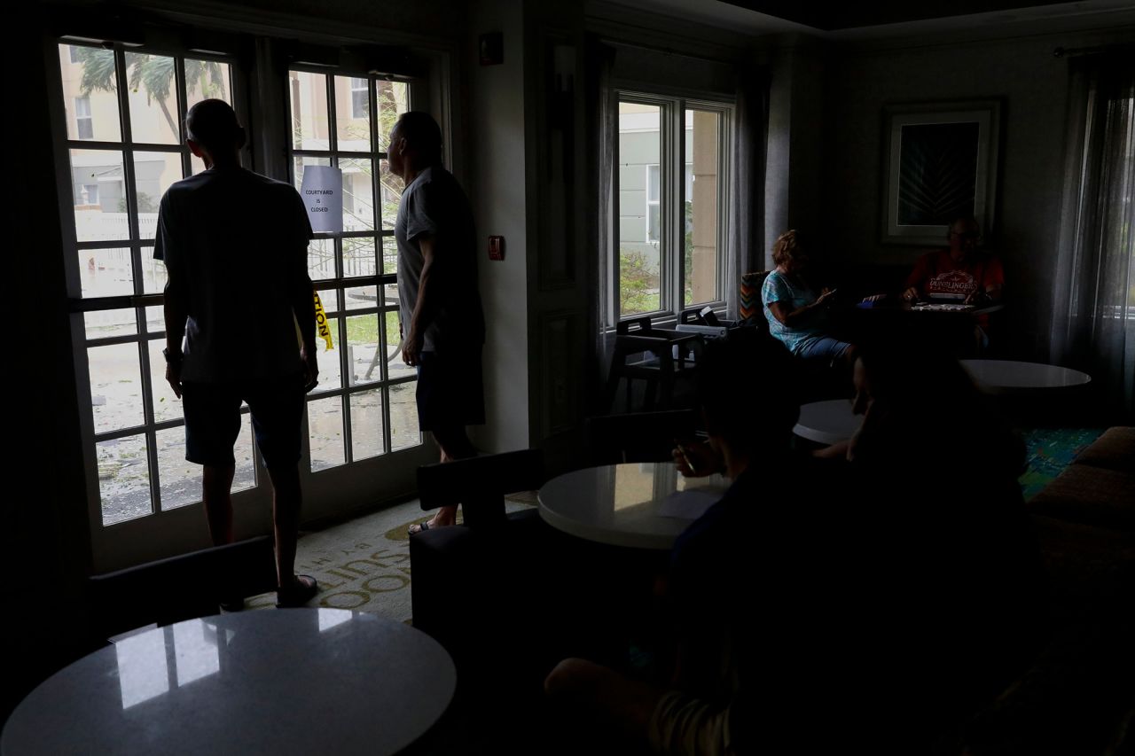 Guests look out of hotel windows as Hurricane Ian has made landfall in Fort Myers, on Wednesday, Sept. 28.