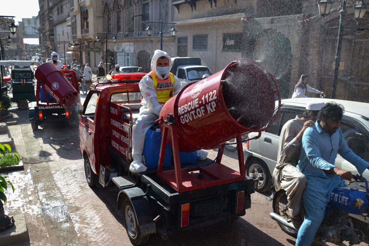 Rescue workers spray disinfectant along a road during a government-imposed nationwide lockdown as a preventative measure against the spread of the coornavirus in Peshawar on May 6. 