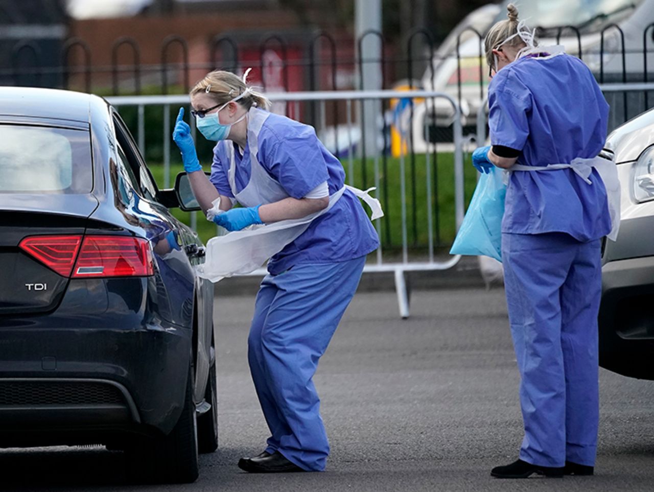  A member of the public is swabbed at a drive through coronavirus testing site set up in a car park on March 12, in Wolverhampton, England. 