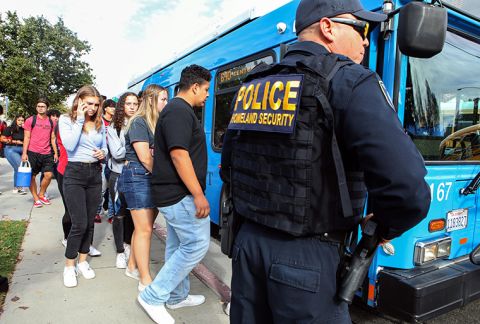 Students are evacuated from Saugus High School onto a bus after a shooting at the school left two students dead and three wounded.