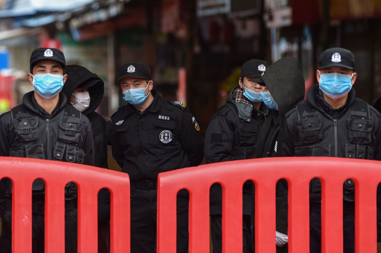 Authorities stand outside the Huanan Seafood Wholesale Market where the coronavirus was detected in Wuhan on January 24.