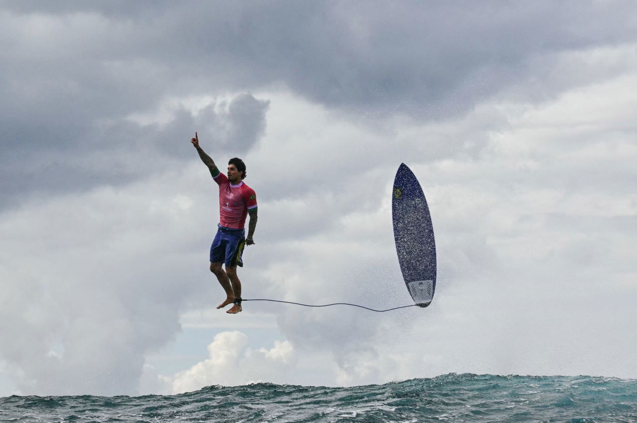 Brazilian surfer Gabriel Medina leaps from his surfboard and raises his finger in the air as he celebrates a near-perfect 9.90-scoring wave July 29. It was the highest-scoring wave in Olympic history. 