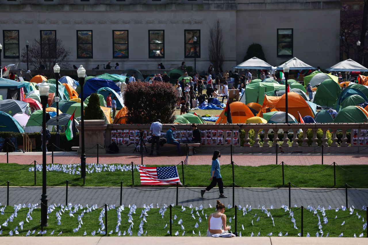 A woman walks past Israeli and US flags alongside portraits of Israelis taken hostage by the militant Palestinian group Hamas in front of the pro-Palestinian encampment at Columbia University in New York on Sunday.