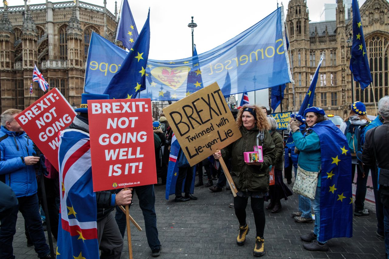 Remainers carry placards reading "Brexit: Not going well is it!" in London on Tuesday.